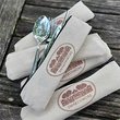 Reusable silver utensils coming out of canvas bag that says "Swarthmore"