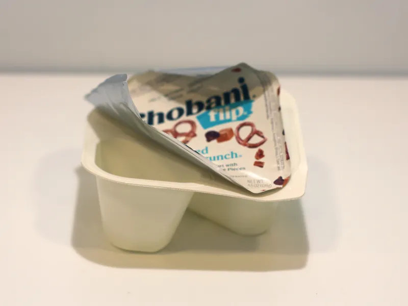 Empty Chobani Flip Yogurt container with lid still attached