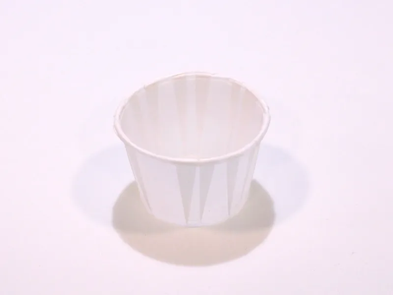 An empty, used condiment cup