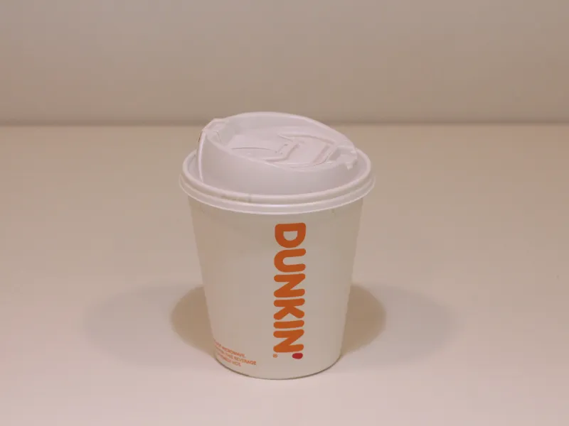 Empty Dunkin Donuts hot cup with lid