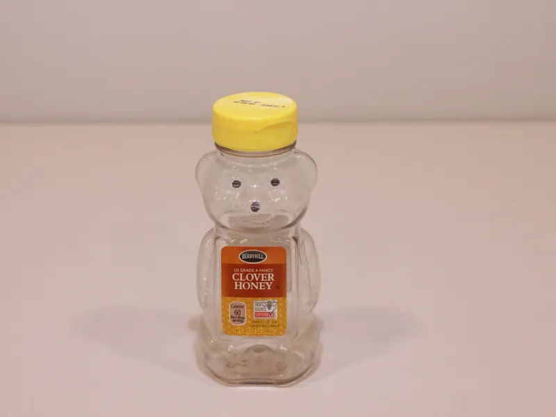 Empty bear-shaped honey bottle