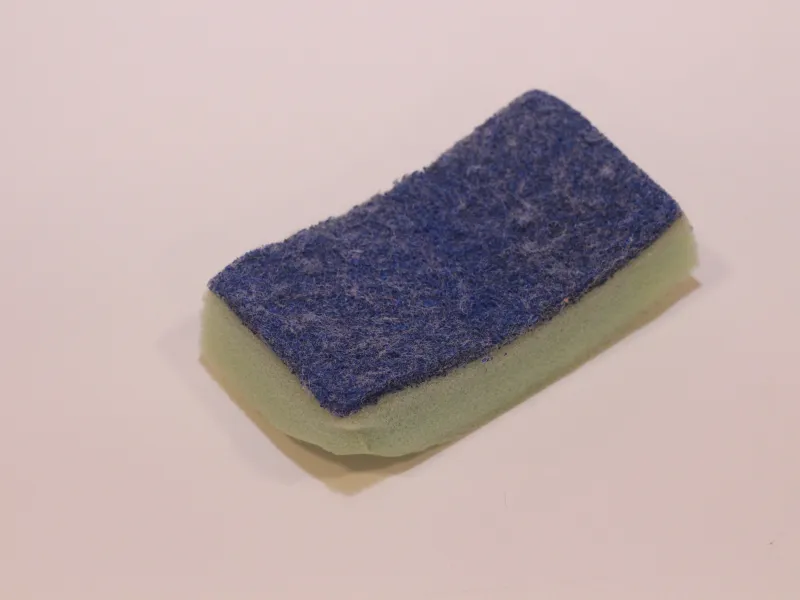 Discarded sponge with scrubbing pad