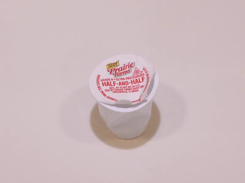 A used creamer cup