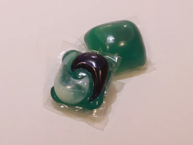 Two green laundry detergent pods