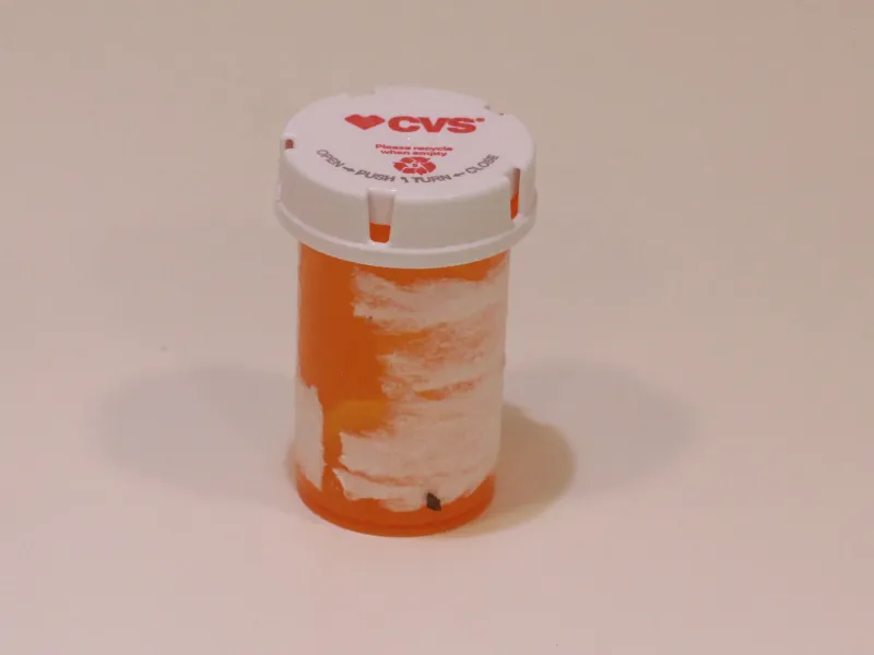 Empty medicine container with label peeled off