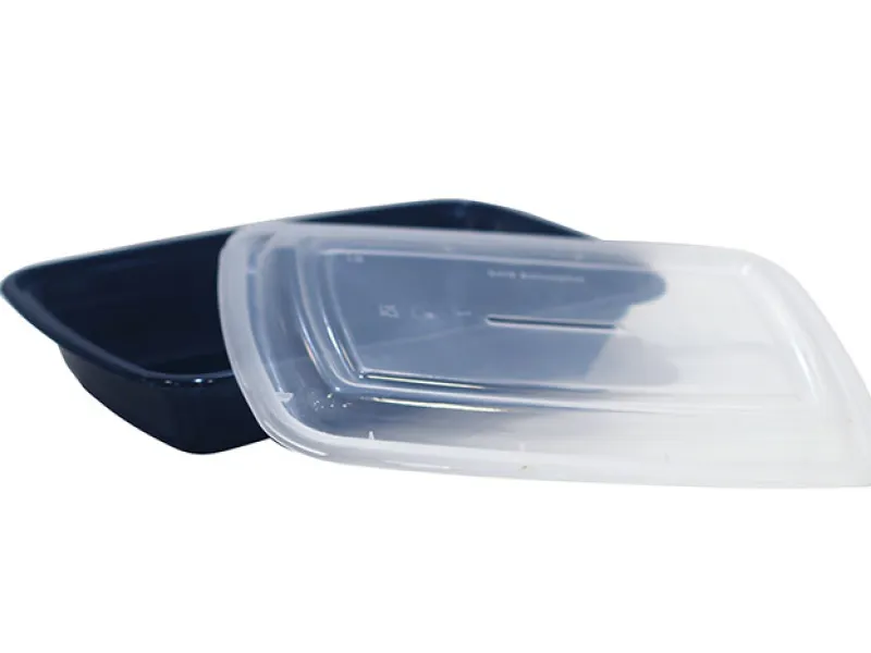 Empty black takeout container with clear lid