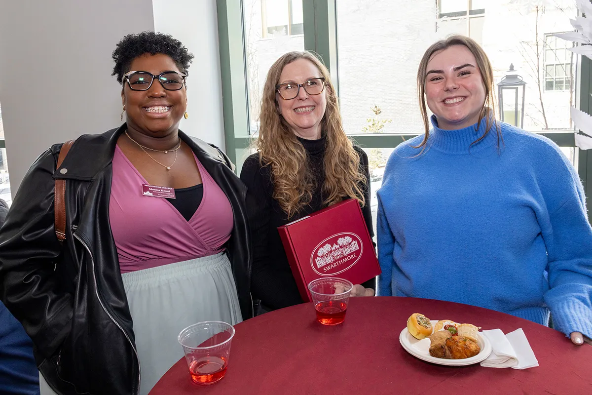 Group of employees at red covered table at winter gathering