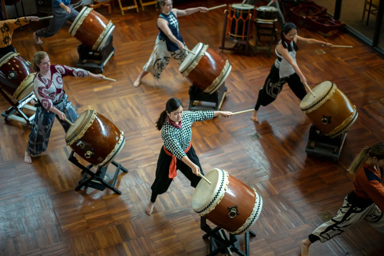 Students do taiko drumming class