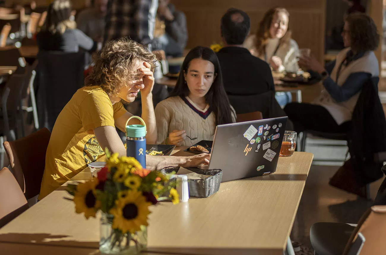 two students using a laptop