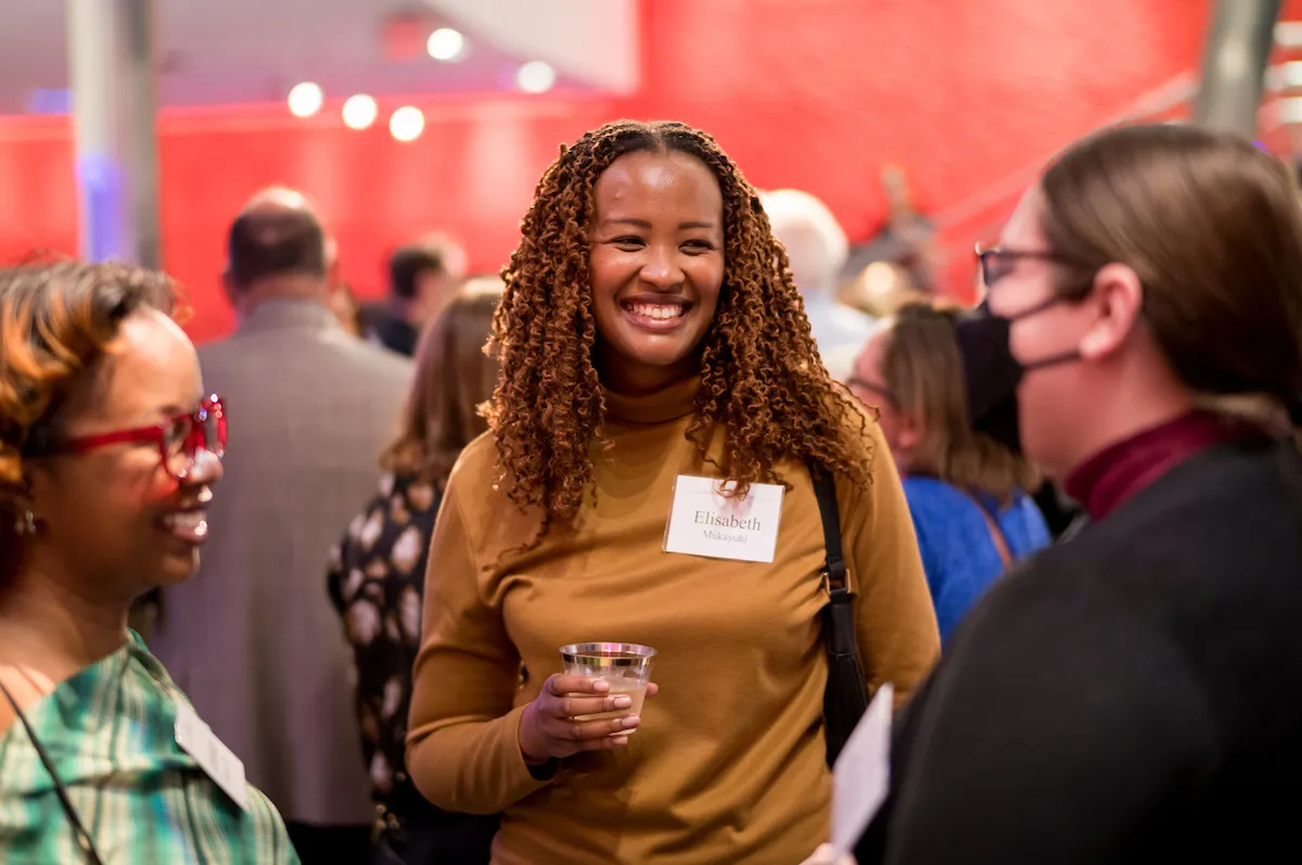 A group of alumni talking at an event