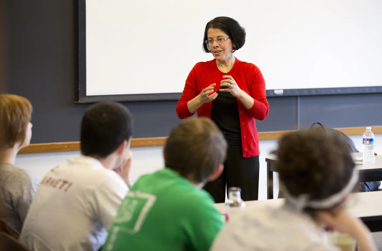Professor Farha Ghannam lecturing to students in front of chalkboard