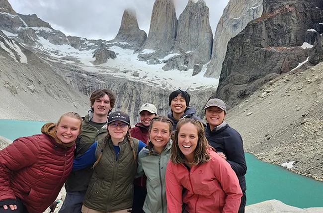 student group in front of a mountain lake and glacier