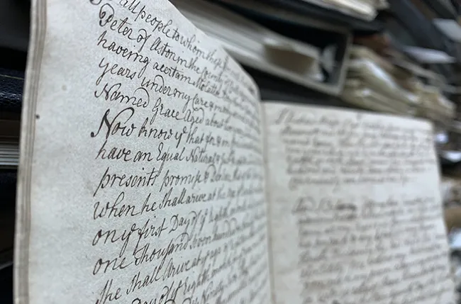 Closeup of an open manuscript with cursive handwriting