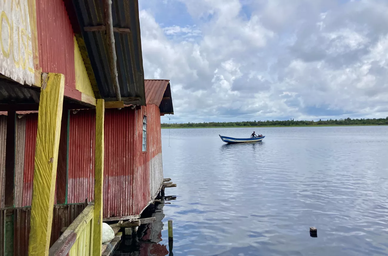 view of lake with a cabin and a boat