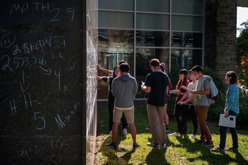 Students use outdoor chalkboard for Math 29 course