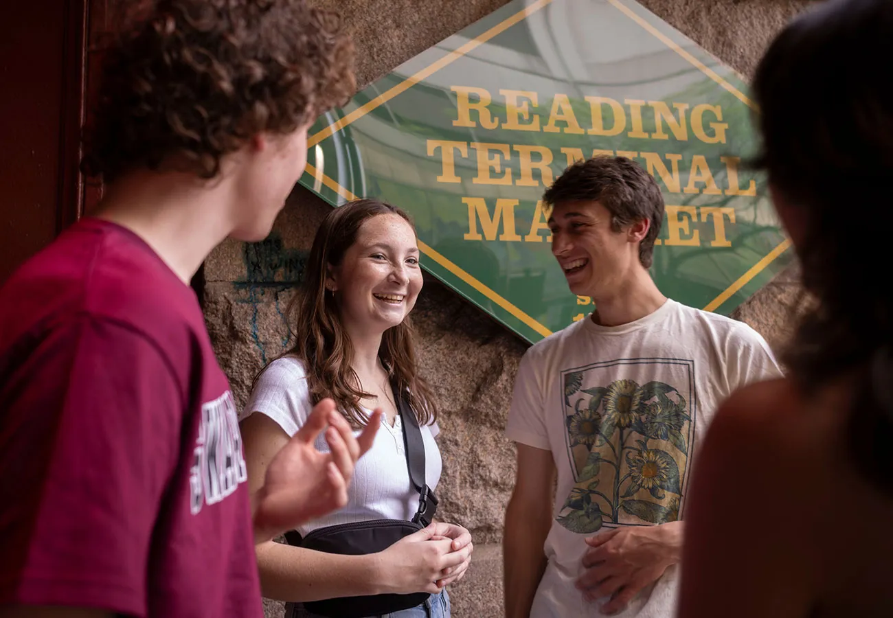 Students outside of Reading Terminal Market sign