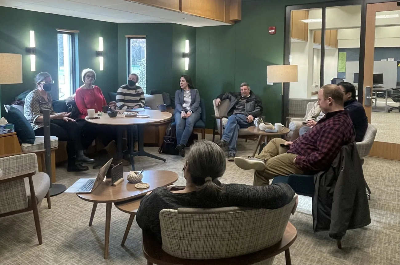 faculty and staff talking and sipping tea