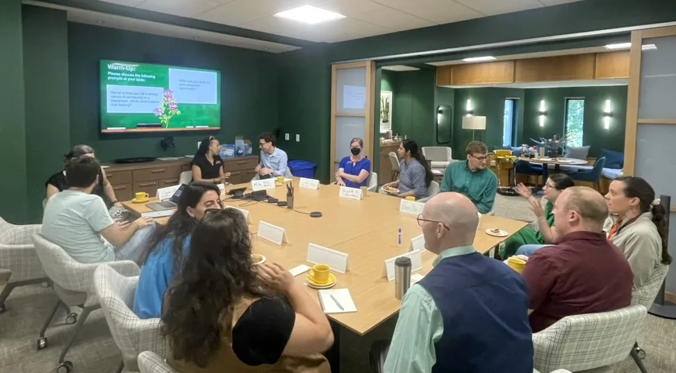 staff chat around a seminar table