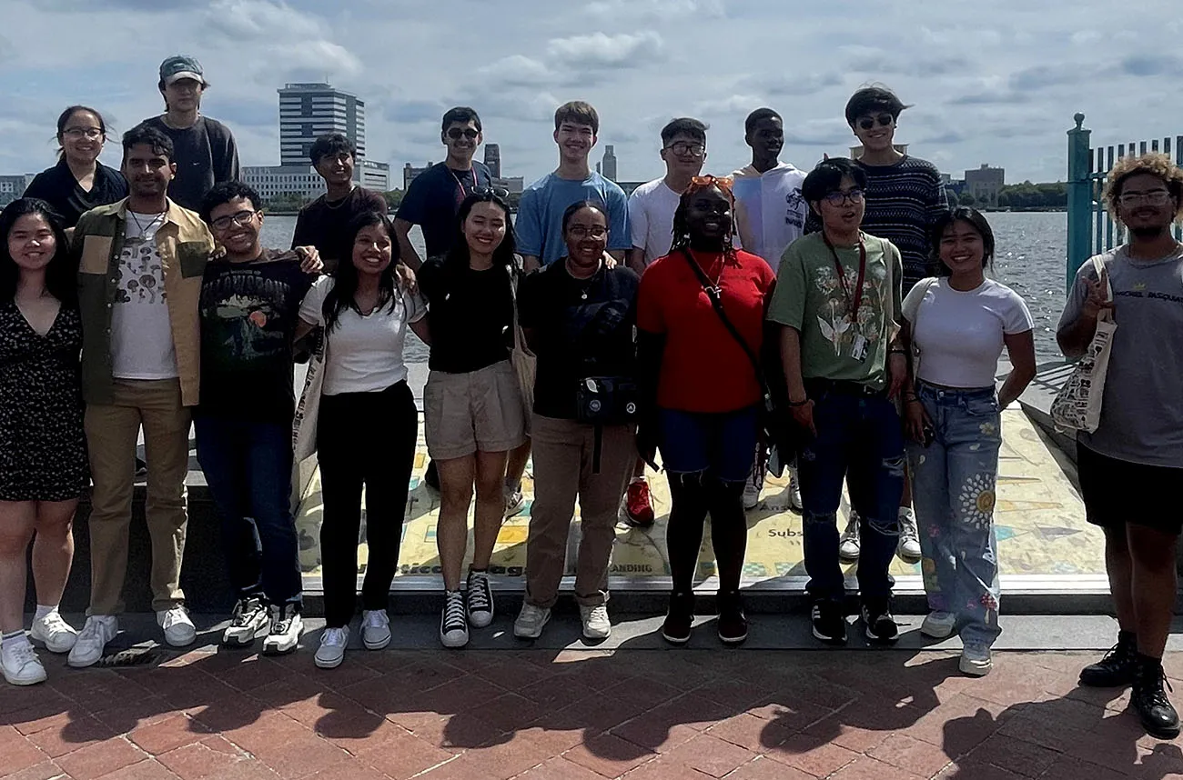 20 students pose in front of Delaware river