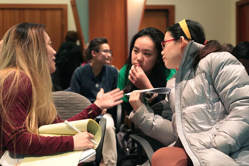 three students talking