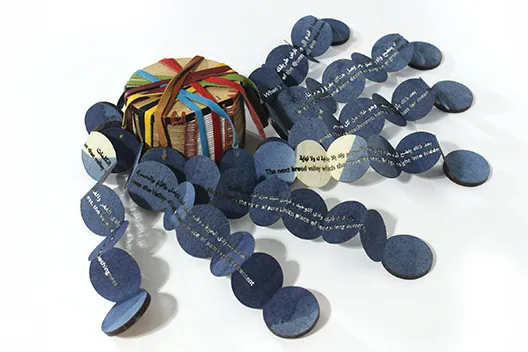 artist book with central hub connecting chains of discs on which Islamic text is written