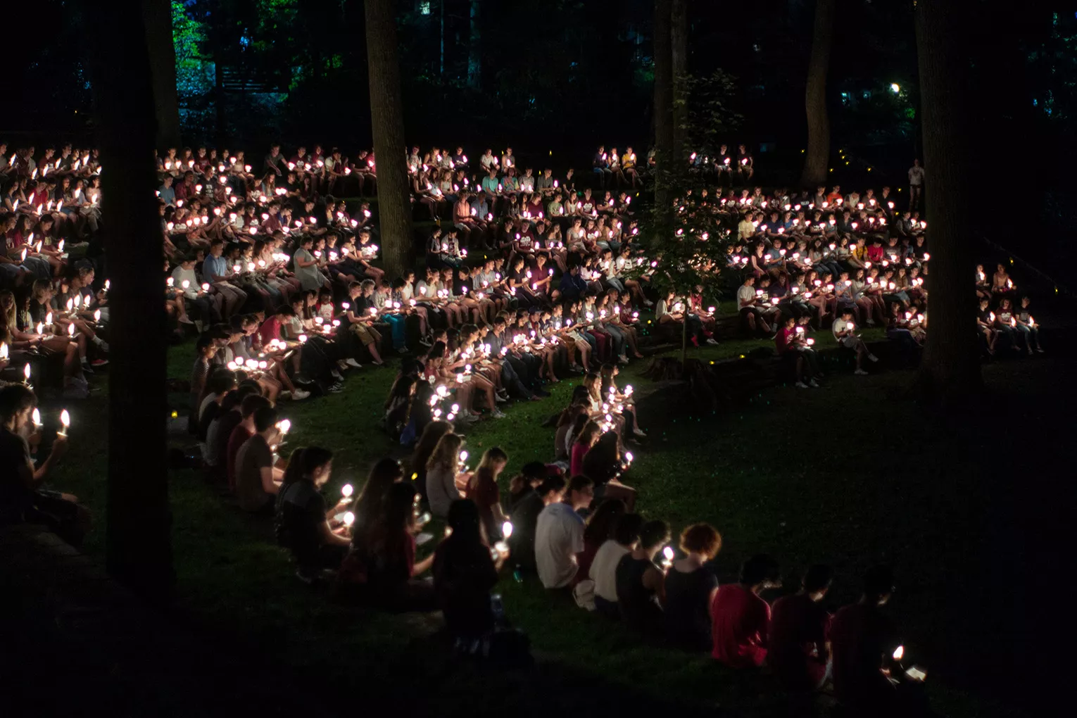 students at first collection with candles