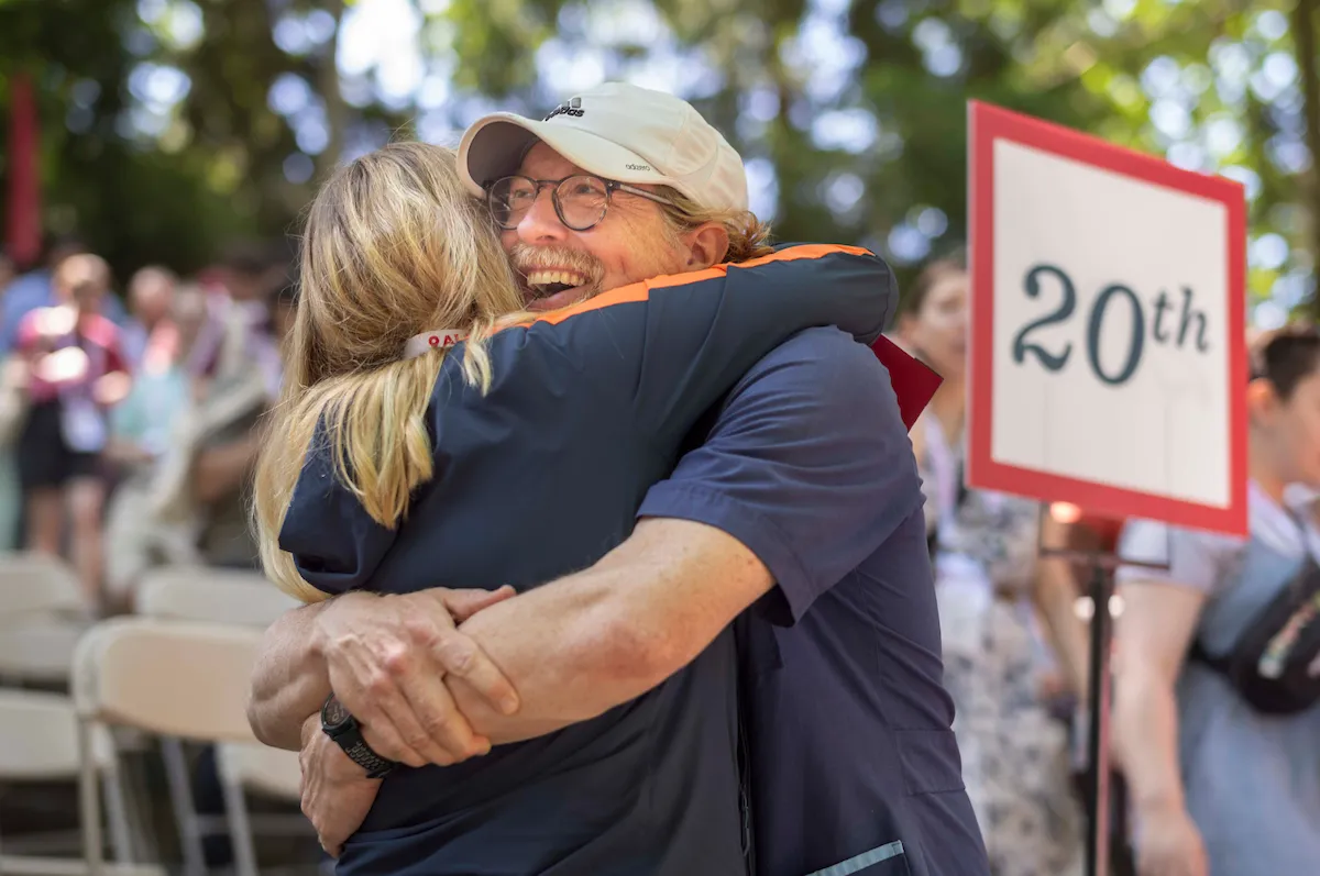 two people hug at alumni weekend reunion