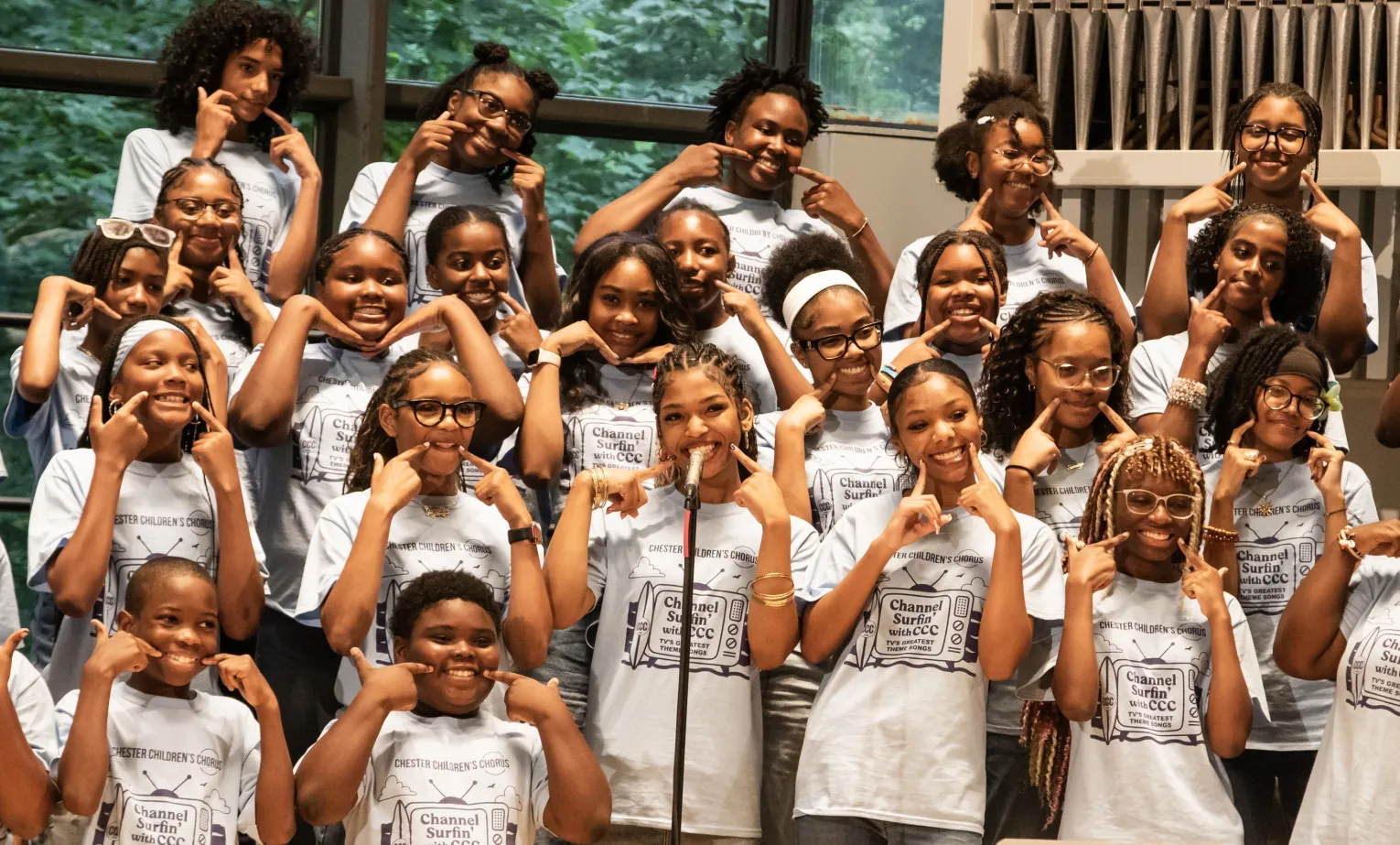 group of boys and girls in a choir on stage 