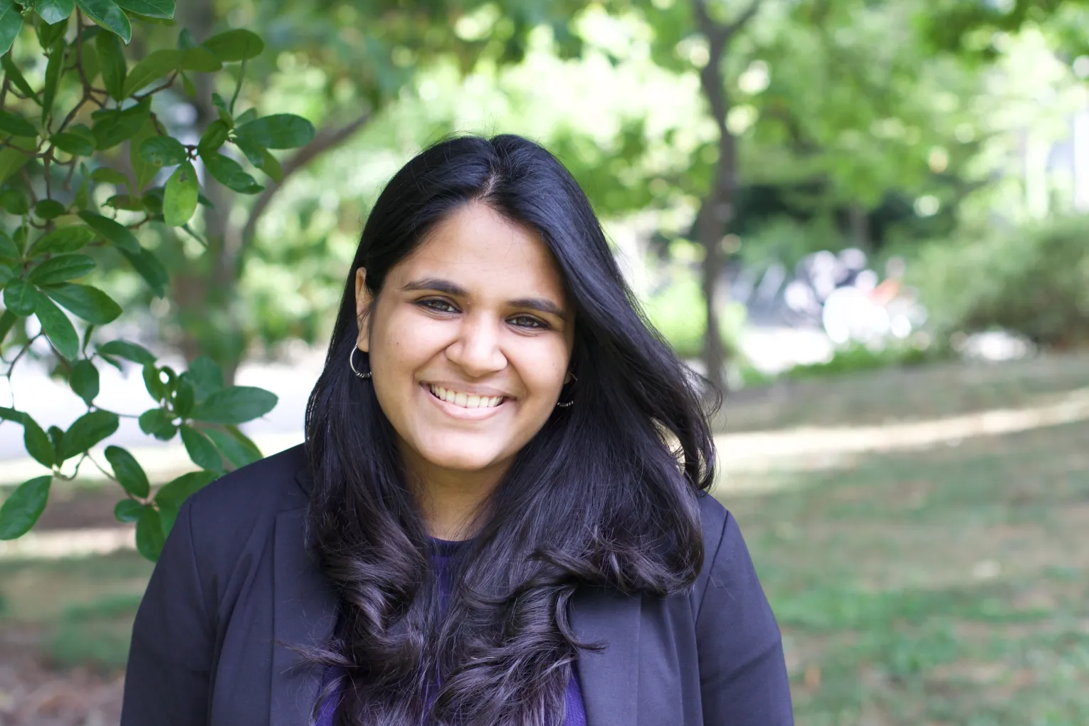 Headshot of Spriha Dhanuka '17. She is outdoors and smiling at the camera.