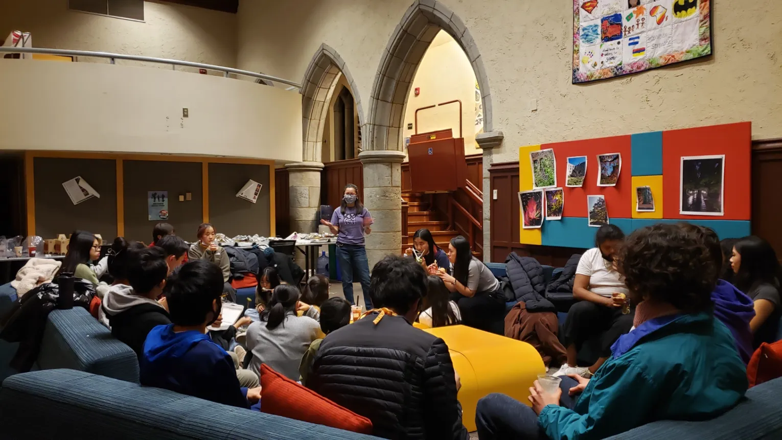 students sitting in circle on colorful couches in the IC Big Room