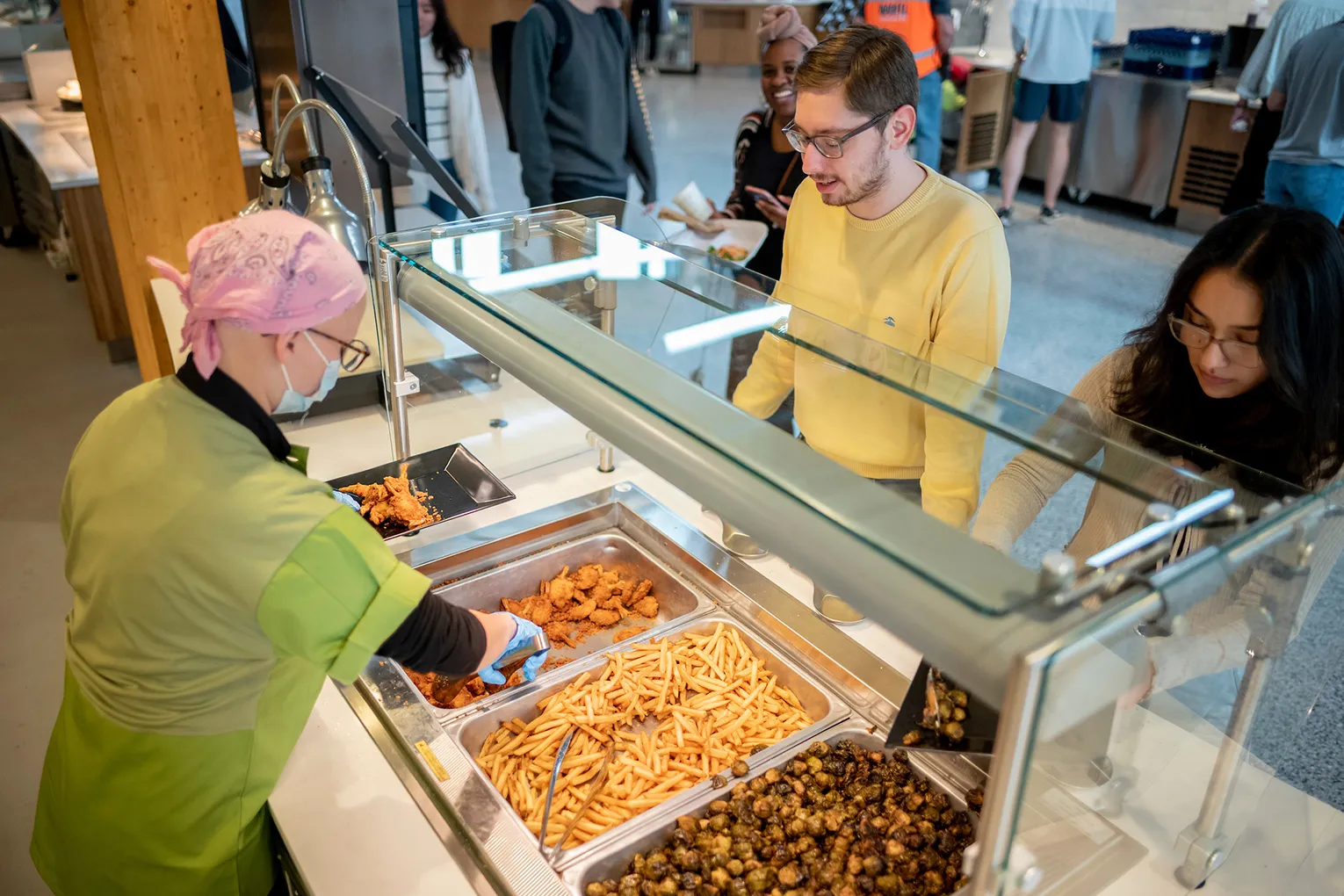 Students being served food at Dining Center