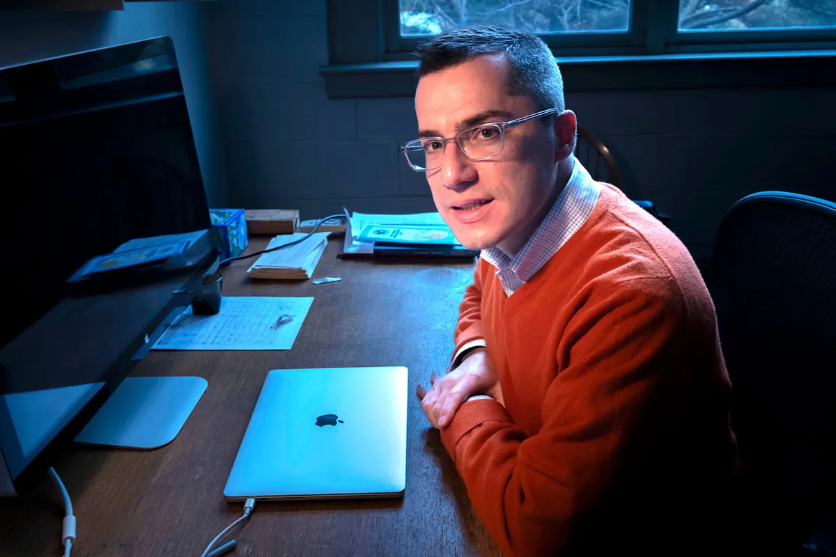Goldstein sits at desk with laptop