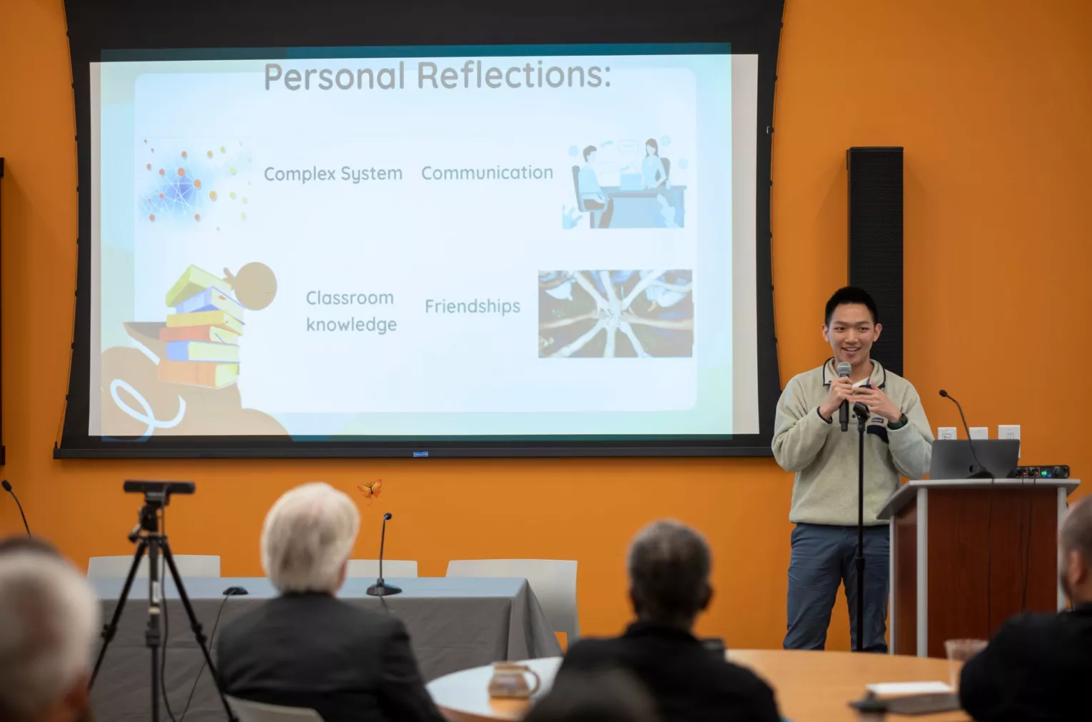 Image of student speaking at podium in front of an audience