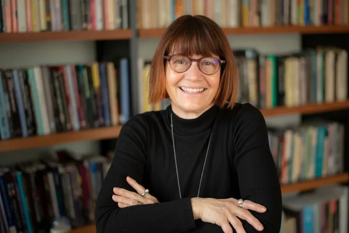 Patty Whitein office in front of bookshelves