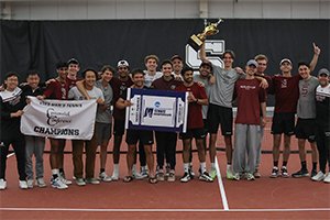 Men's tennis team celebrates with conference trophy on court