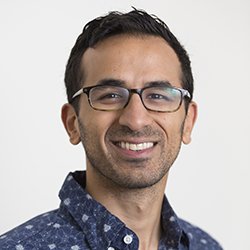 Syon Bhanot smiling against white background