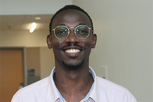 Student wearing glasses smiles for indoor portrait