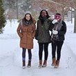 three students walking in the snow