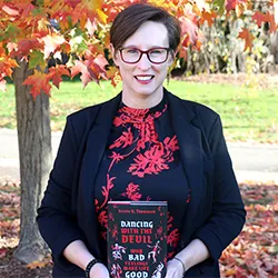 Krista Thomason holds up book entitled "Dancing with the Devil: Why Bad Feelings Make Life Good"