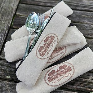 Reusable silver utensils coming out of canvas bag that says 