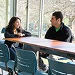 two students talking in renovated willets lounge