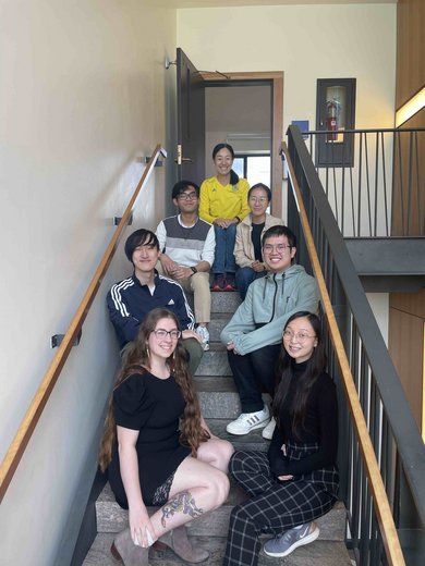 Students and faculty posing on a Kohlberg staircase