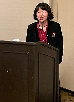 Jasmine Bao delivers paper at podium