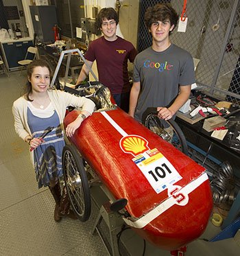 Students stand with their eco car