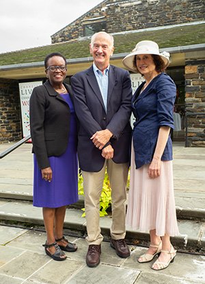 Valerie Smith, Gil Kemp '72 and Barbara Guss stand in front of Sharples
