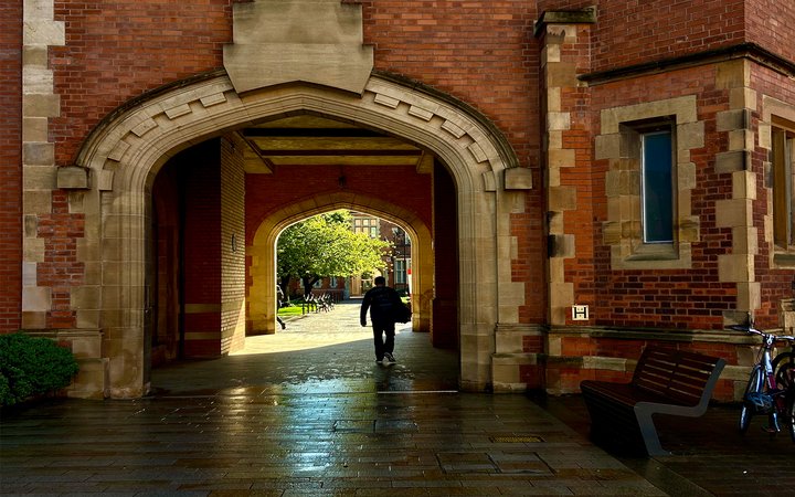 Arched entrance to path through buildings on a campus
