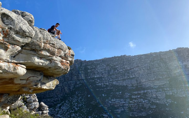 Student sitting on cliff