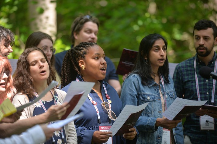 Group of alumni sing in choir