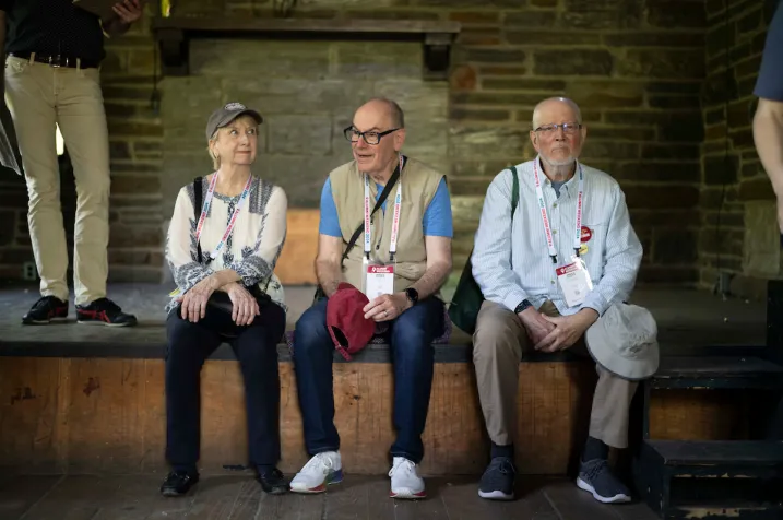 Three alumni sit on stage at empty Olde Club venue