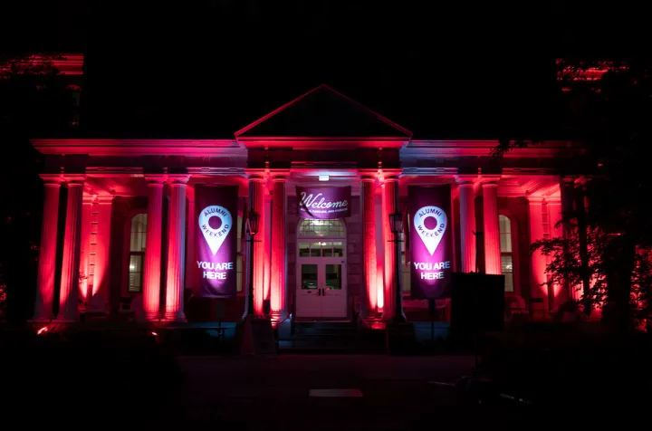 Parrish Hall lit up at night with red